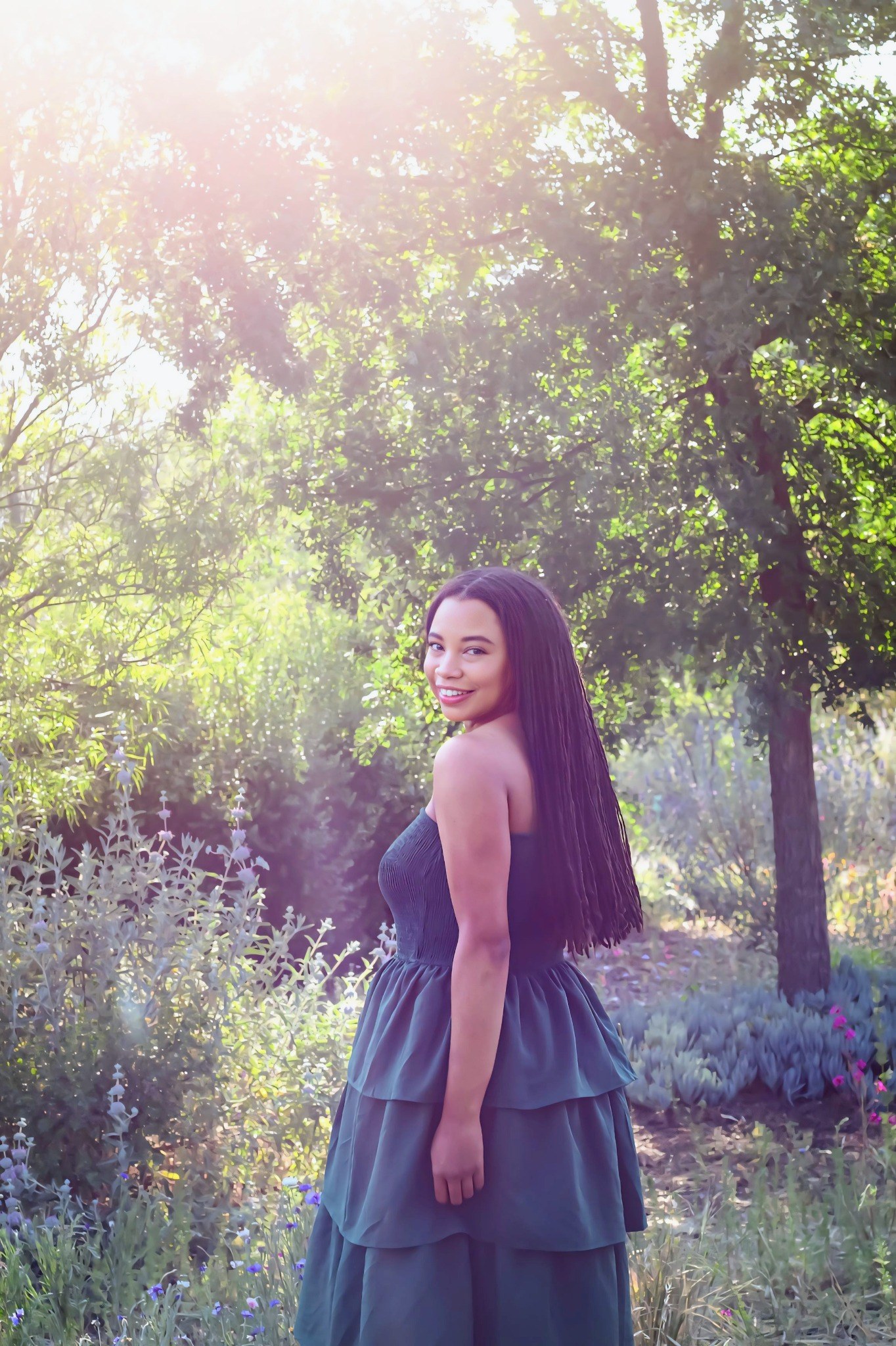 Katiara Faulkner smiling in a sunlit garden